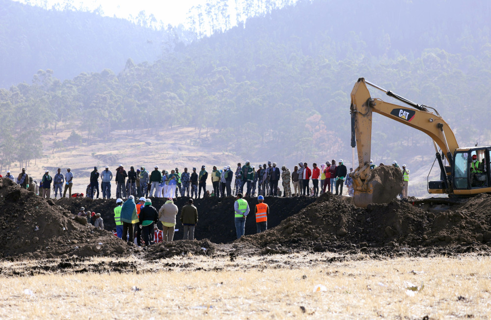 Search and rescue mission members look on as a digger searches for dead bodies at the scene of the Ethiopian Airlines Flight ET 302 plane crash, near Bishoftu, southeast of Addis Ababa, Ethiopia March 11, 2019. u00e2u20acu201d Reuters pic 